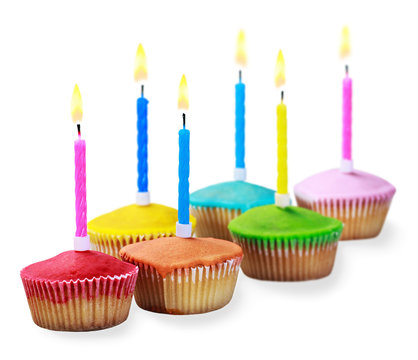Birthday cupcakes in different colors isolated