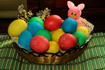 Colourful easter eggs in a basket anddecorations