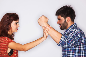 Closeup of a man fist held back by his girlfriend