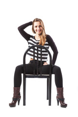 Fototapeta premium Relaxed woman sitting on a chair is smiling