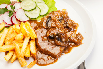 Pork chop with sauce, mushrooms and chips