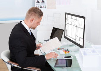 Businessman analyzing a spreadsheet online checking