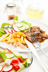 Pork chop with sauce, mushrooms and chips