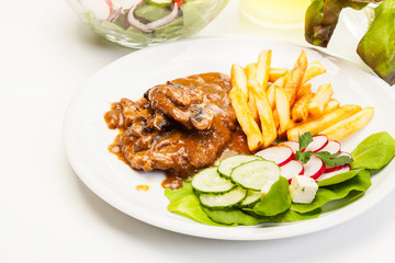 Pork chop with sauce, mushrooms and chips