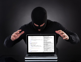 Hacker stealing data of a laptop computer