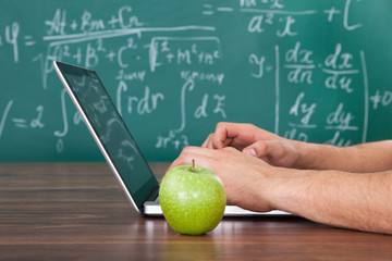 Student Solving Math's Problem On Laptop