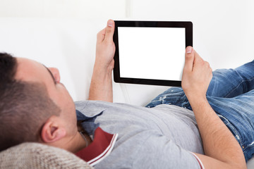 Man Using Digital Tablet On Sofa