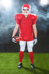 Portrait Of Confident American Football Player On Field