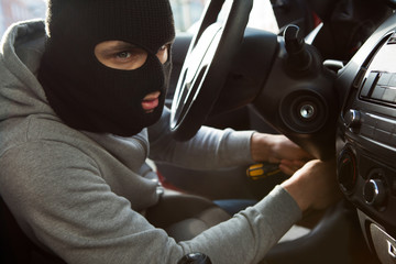 Thief Using Screwdriver In Car