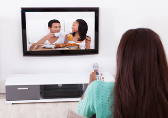 Woman Watching TV In Living Room