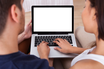 Young Couple Using Laptop Together