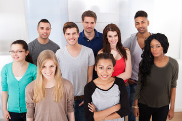 Portrait Of College Students Standing In Classroom