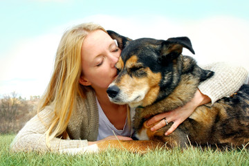 Woman Tenderly Hugging and Kissing Pet Dog