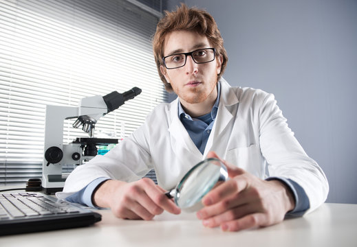 Young researcher with magnifier