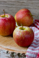 Apples in water drop on a wooden board, rustic style