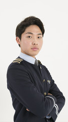 Asian airline pilot with his arms crossed