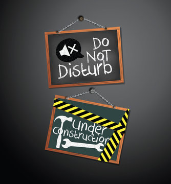 Under construction and do not disturb Signs on blackboard