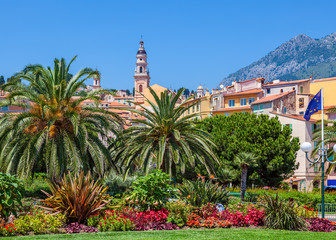 Colorful houses, green trees and palms in Menton.