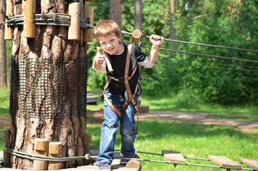 Happy boy in rope park