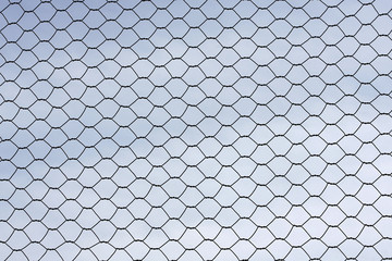 Metal wire fence protection isolated on sky for background