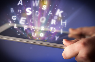 Finger pointing on tablet pc, letters concept