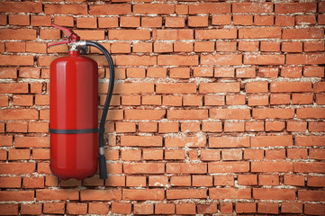 fire extinguisher on brick wall