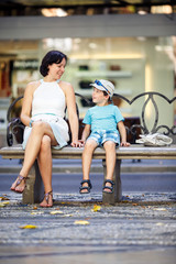 Portrait of mother and son sitting outdoors