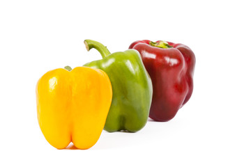 red green and yellow pepper isolated on white