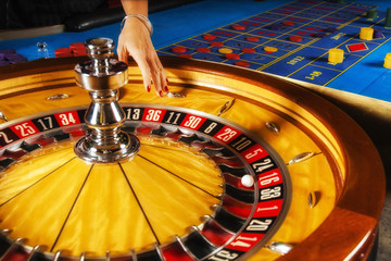 Roulette wheel and croupier hand.
