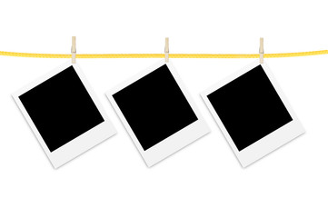 Old photo cards hung with wooden hangers over white