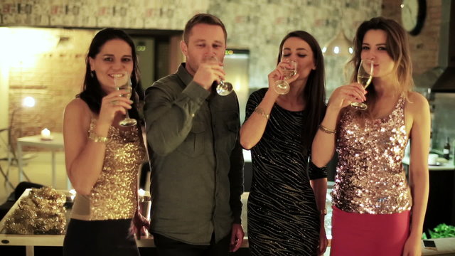 friends toasting glasses of champagne to the camera 