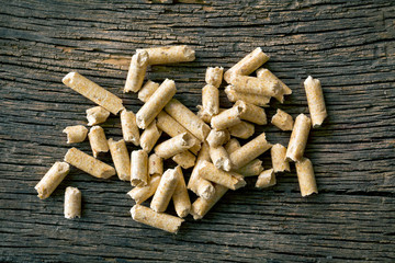 wooden pellets on old wooden background