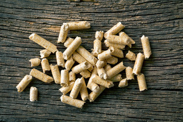 wooden pellets on old wooden background