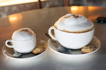 Two cups of cappuccino on table
