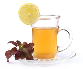 Cup of herbal tea with red tulsi leaves and lemon