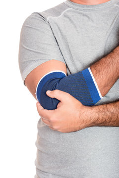 Man with a therapeutic elastic band on his elbow