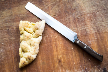 white flat pizza and a knife