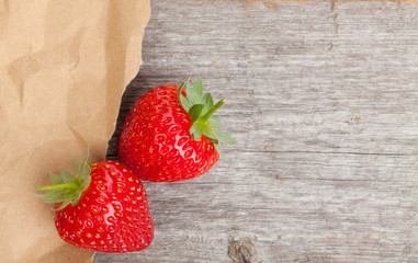 Ripe strawberries over wooden table background