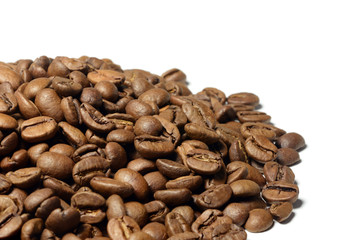 Hill of brown coffee beans isolated on white