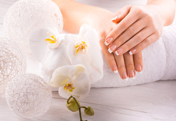 Obraz na płótnie Canvas beautiful french manicure with white orchid