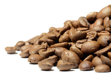 Hill of brown coffee beans isolated on white
