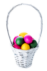 Colorful easter eggs in basket isolated on white background clos