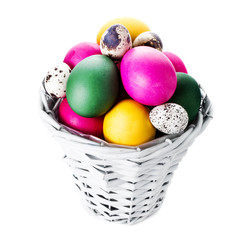 Colorful easter eggs in basket isolated on white background clos