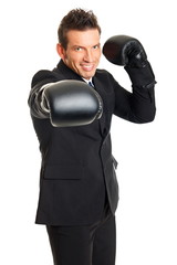 Handsome man in suit standing with boxing gloves on his hands