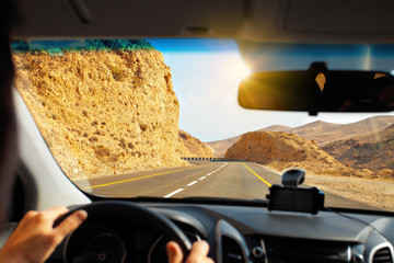 Driving a car on mountain road to Dead Sea