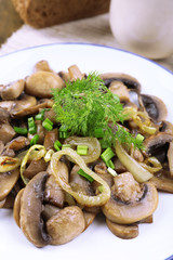 Delicious fried mushrooms on plate on table close-up