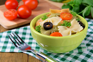 Delicious pasta with tomatoes on plate on table close-up