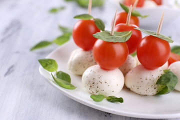 Tasty mozzarella cheese with basil and tomatoes