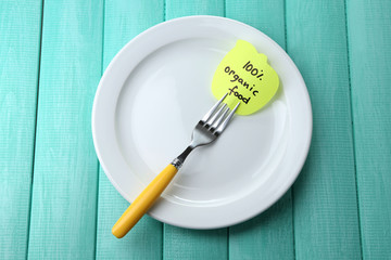 Note paper with message  attached to fork,