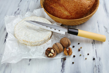 Tasty Italian cheese and bread on wooden table